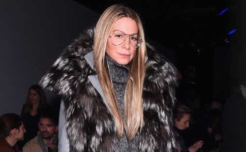 Jewelry designer Jennifer Fisher stands in a dark, faux fur coat while out at an evening event.