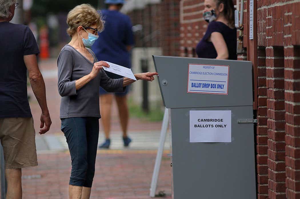 woman at a ballot drop box