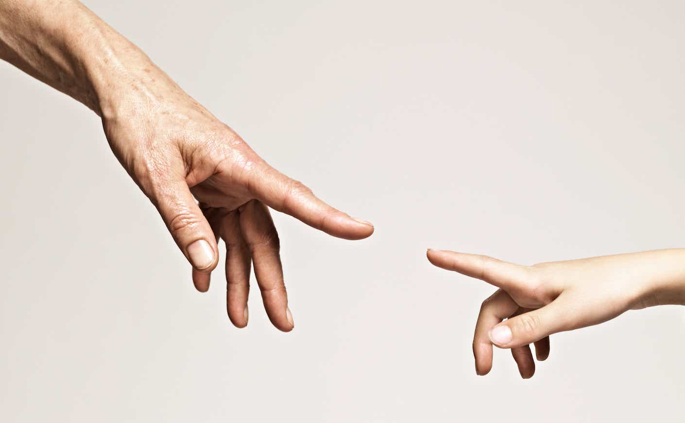 Young and old hands point together