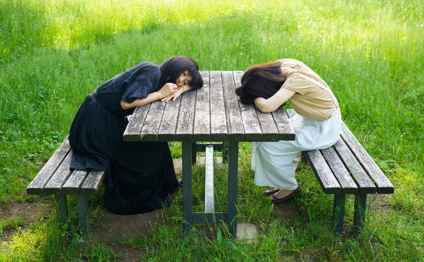 Two women sleeping in the park