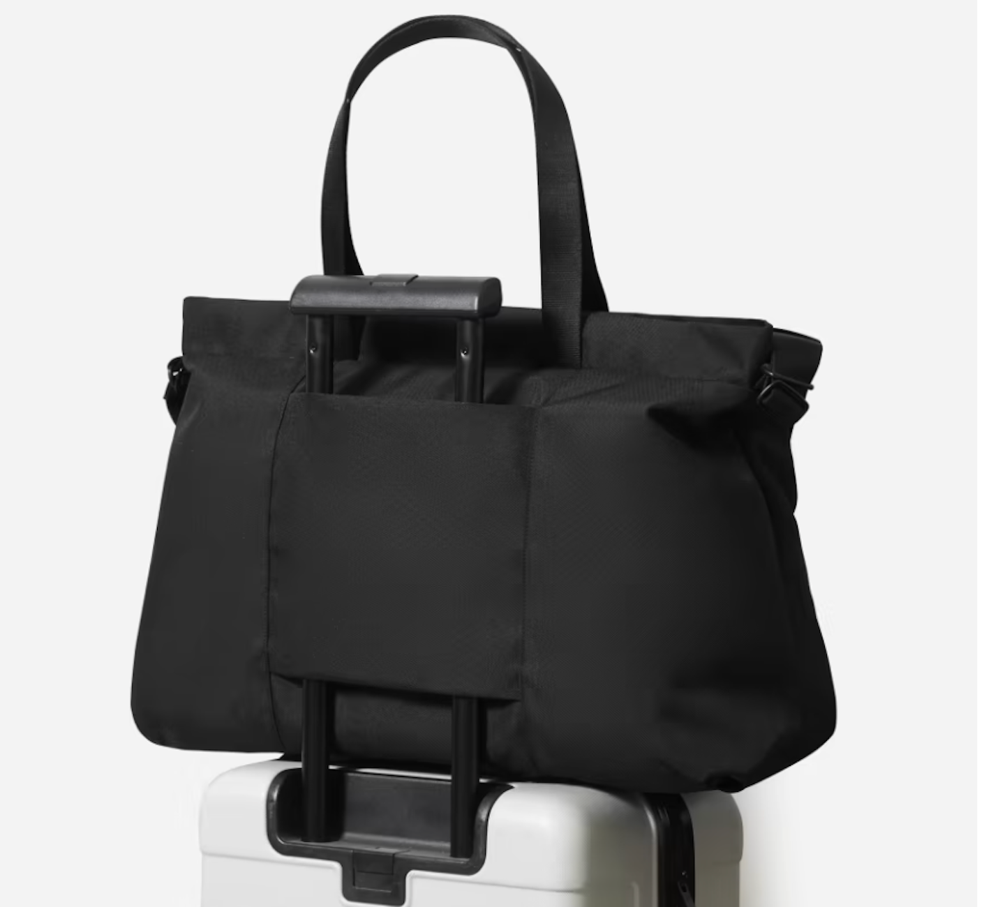 black Everlane duffle bag on top of suitcase