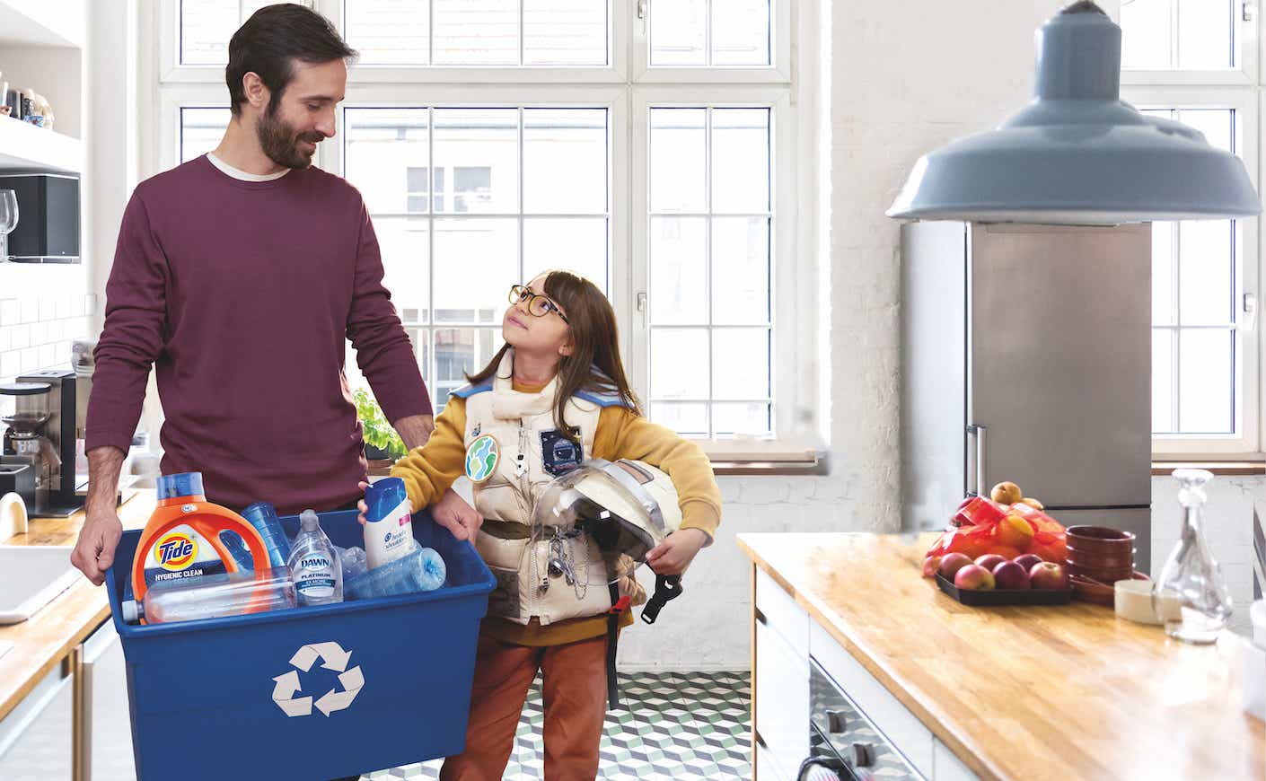 Dad teaching daughter to recycle