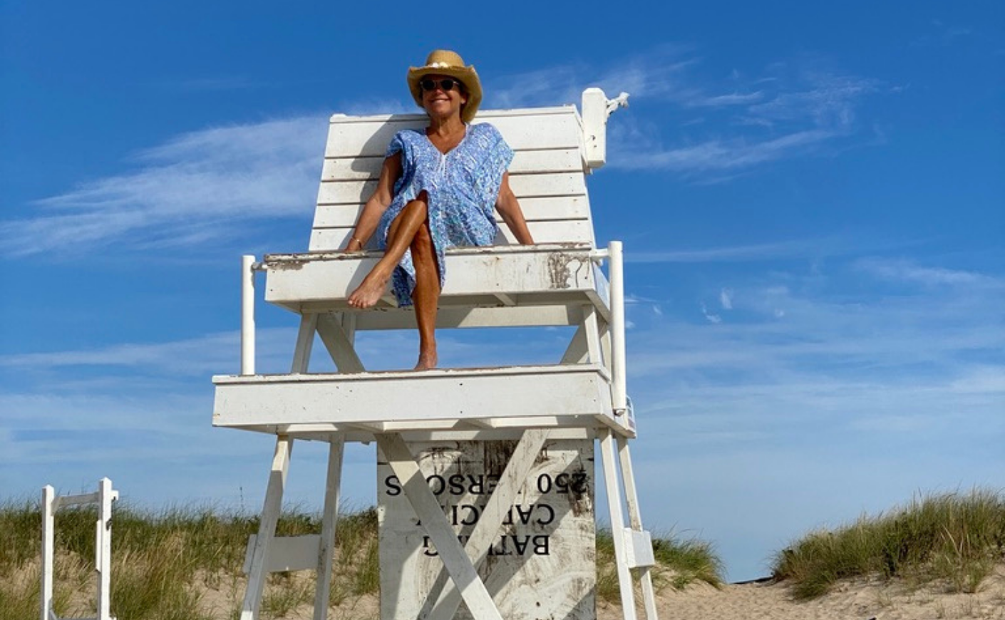 woman sitting on a lifeguard chair