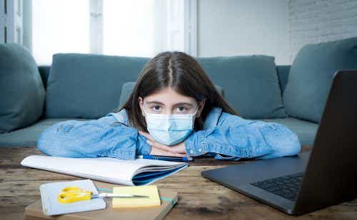 Bored,And,Depressed,Teenager,Girl,With,Face,Mask,On,Laptop