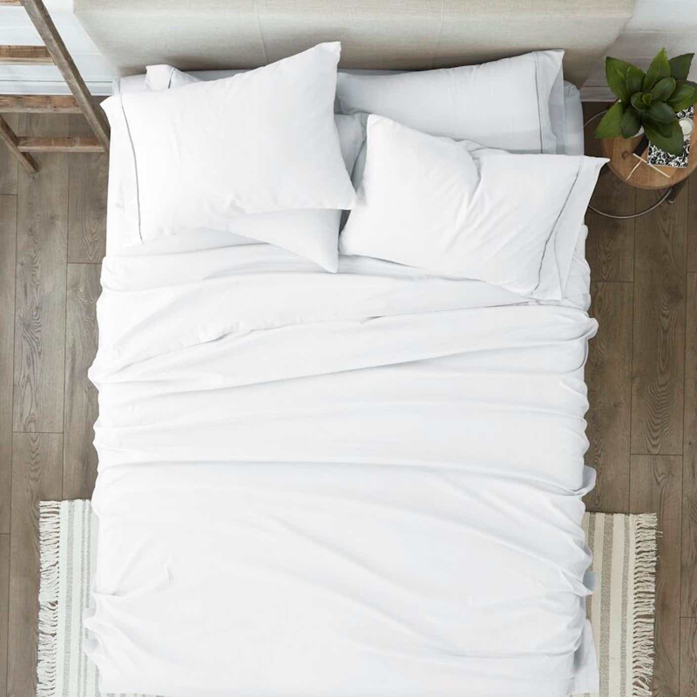 bed with white sheets and pillows