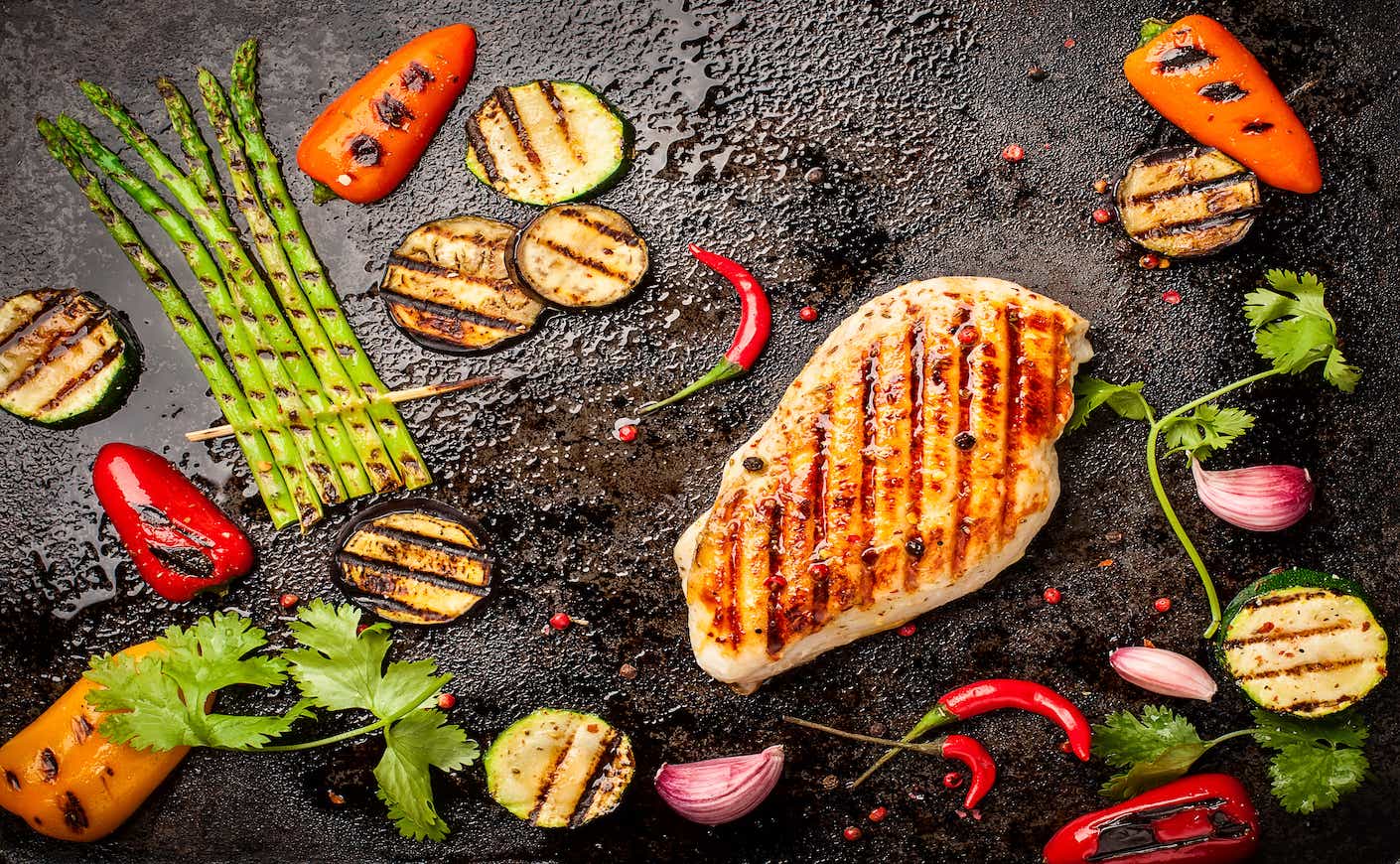 Spicy grilled chicken breast with herbs and grilled vegetables