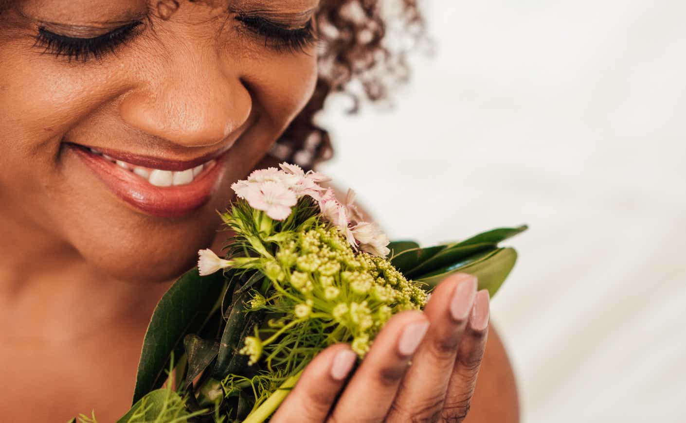 ¨Woman smelling some flowers