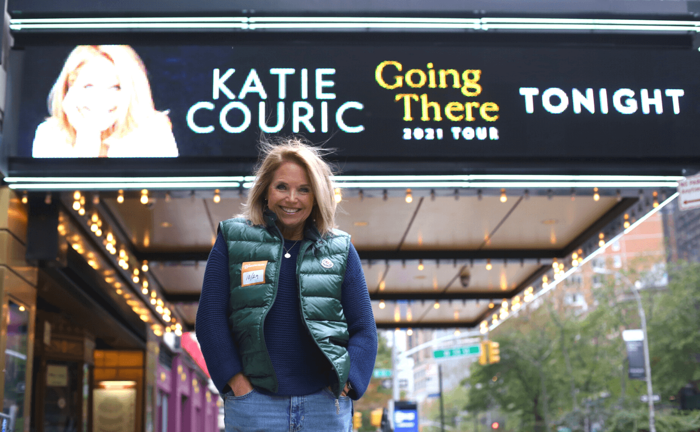 Katie Couric Going There Tour green vest blue sweater outfit 