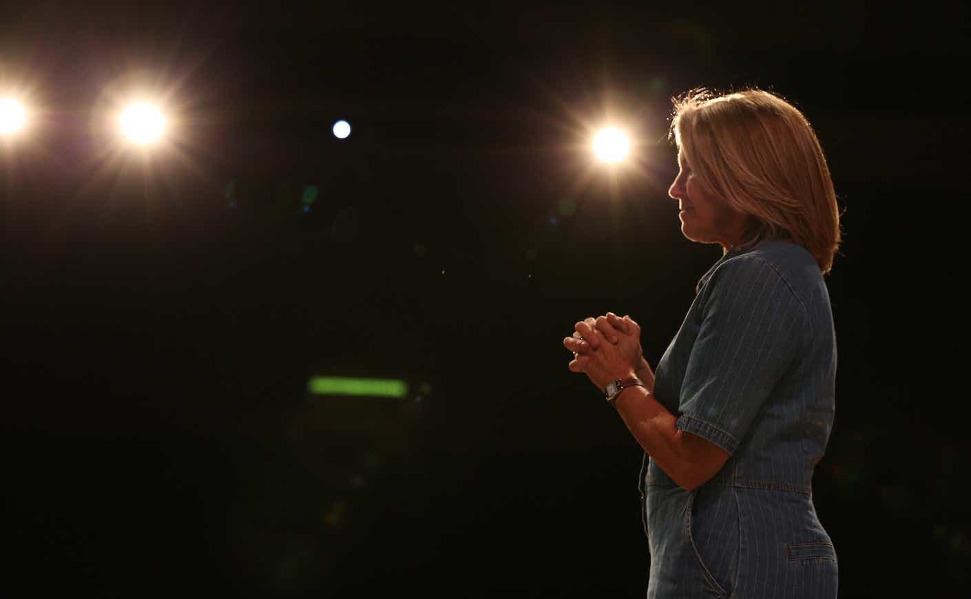 Katie Couric crossing hands as she speaks to her audience