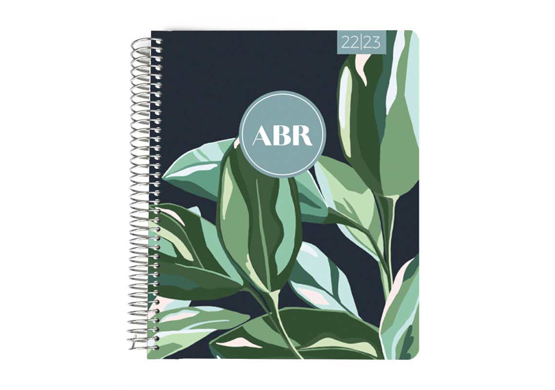 plum paper planner with leaves on the cover and initials