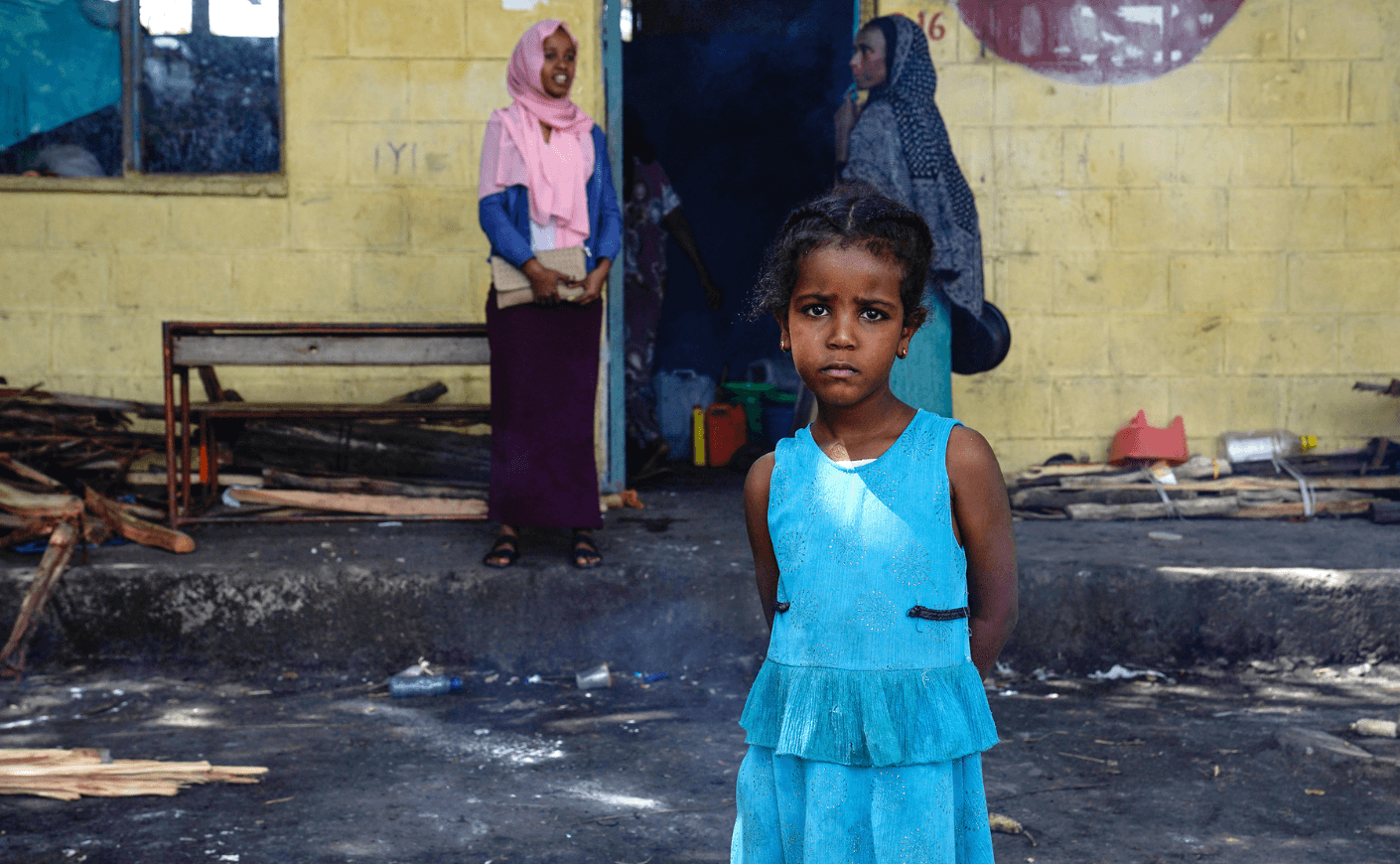 girl in blue dress in Ethiopia in refugee camp