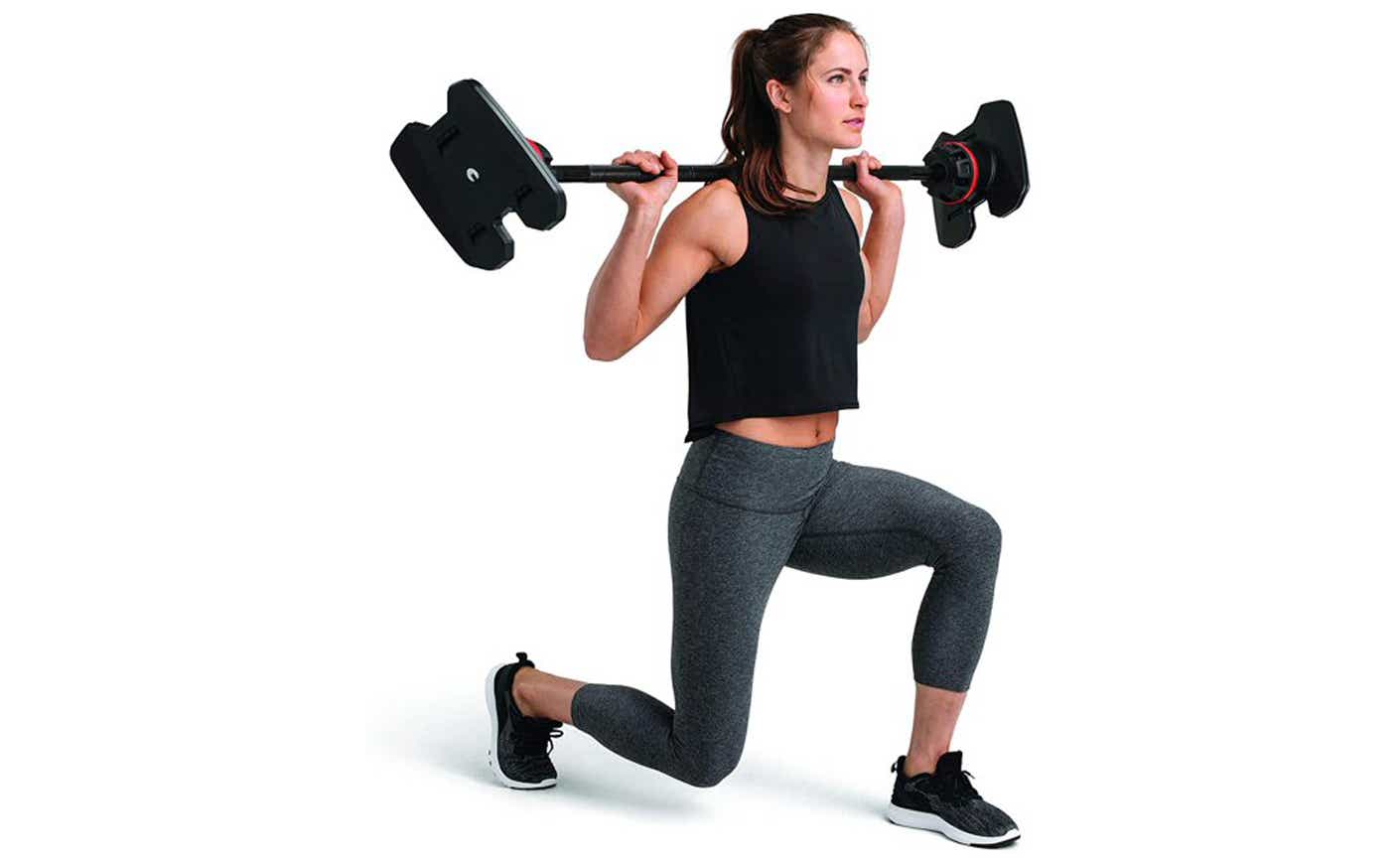 woman lifting bowflex barbell