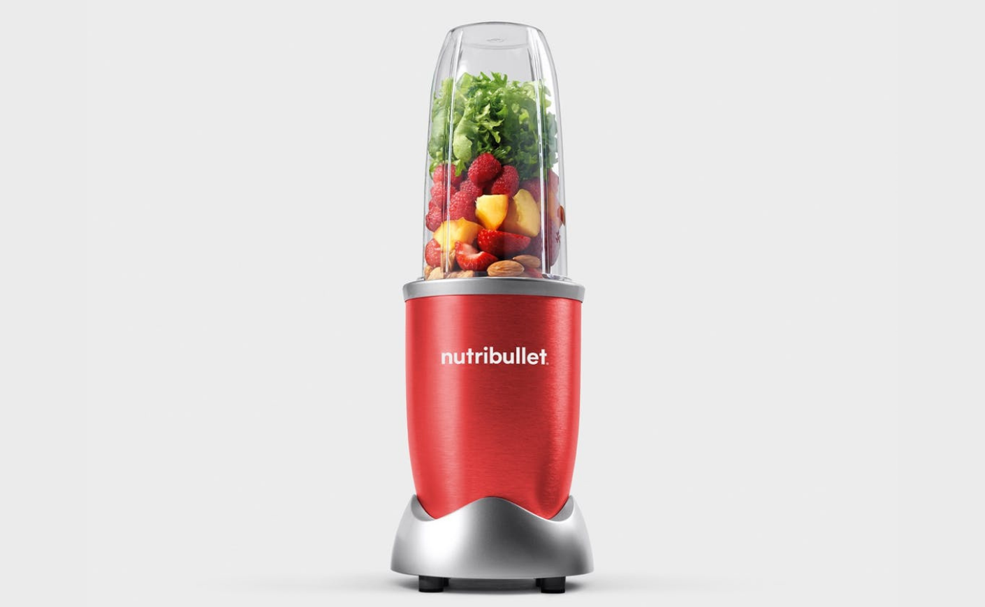 red nutribullet blender with fruits and vegetables