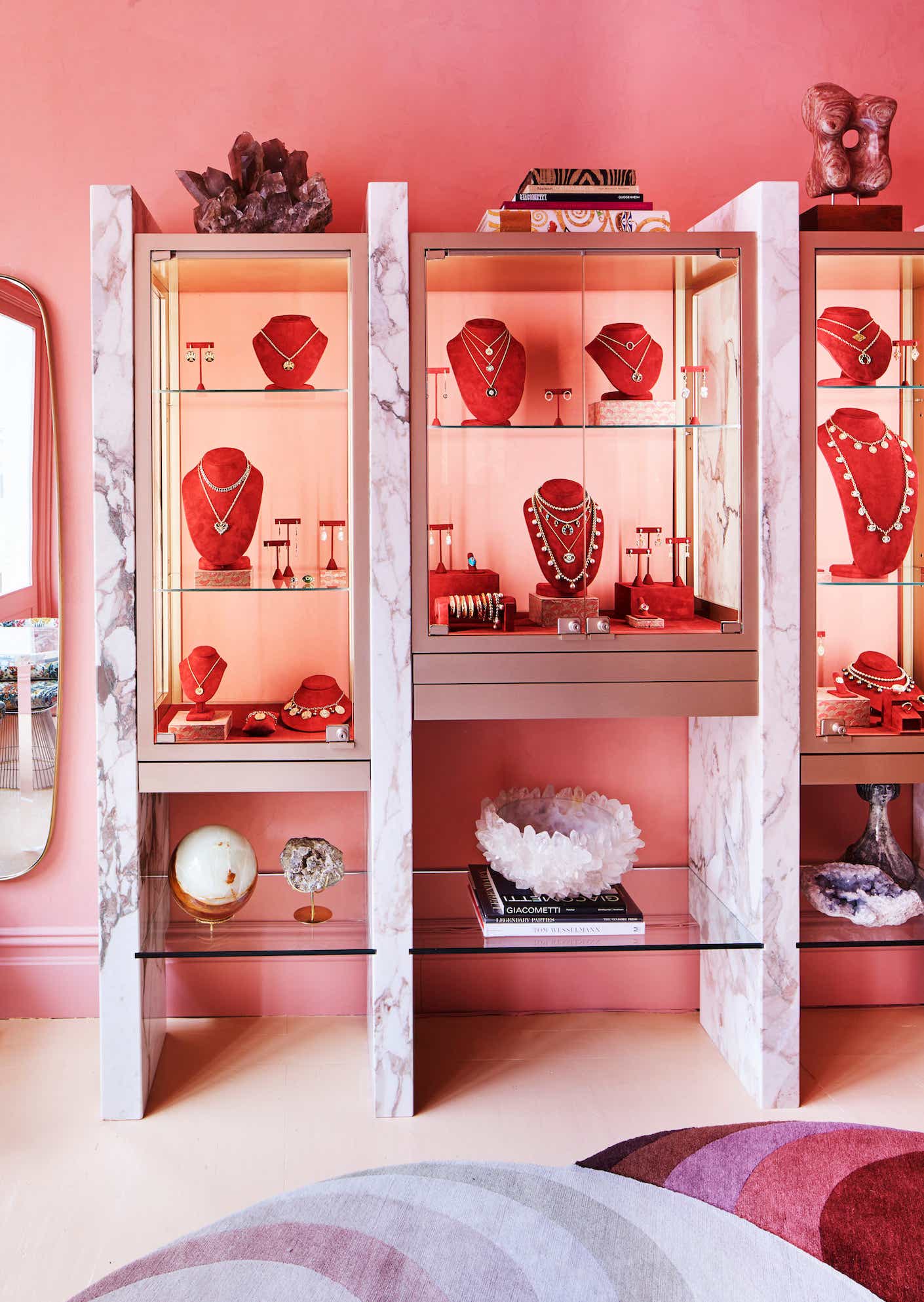 inside jewelry store Marlo Laz with necklaces, earrings, rings and bracelets on display in pink cases