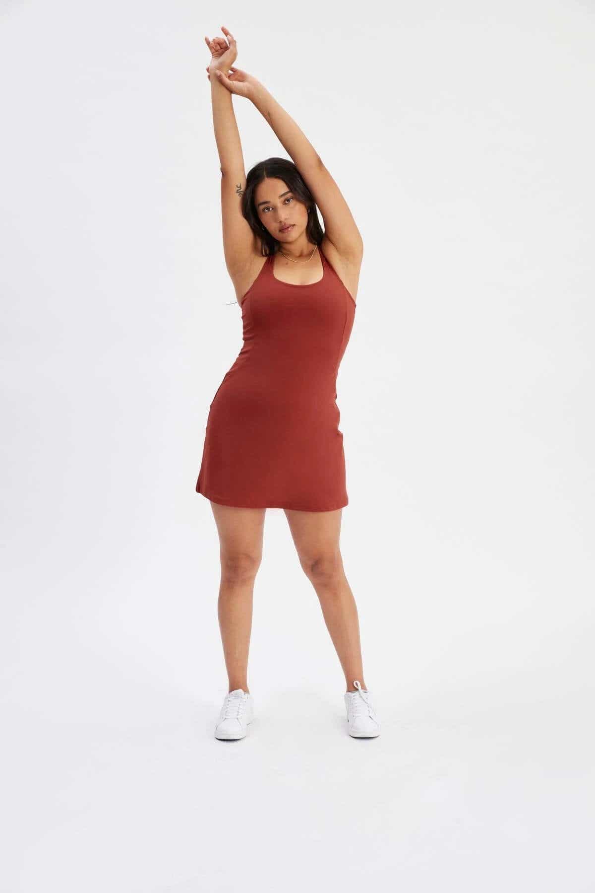 model standing in red workout dress