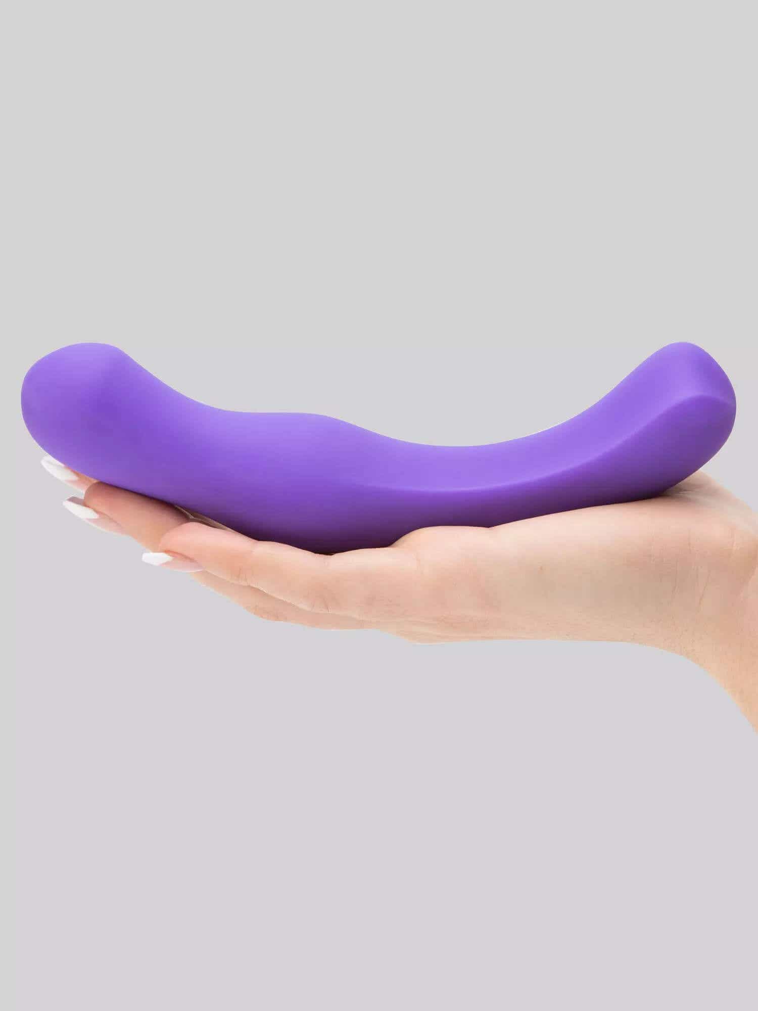 purple silicone dildo in hand