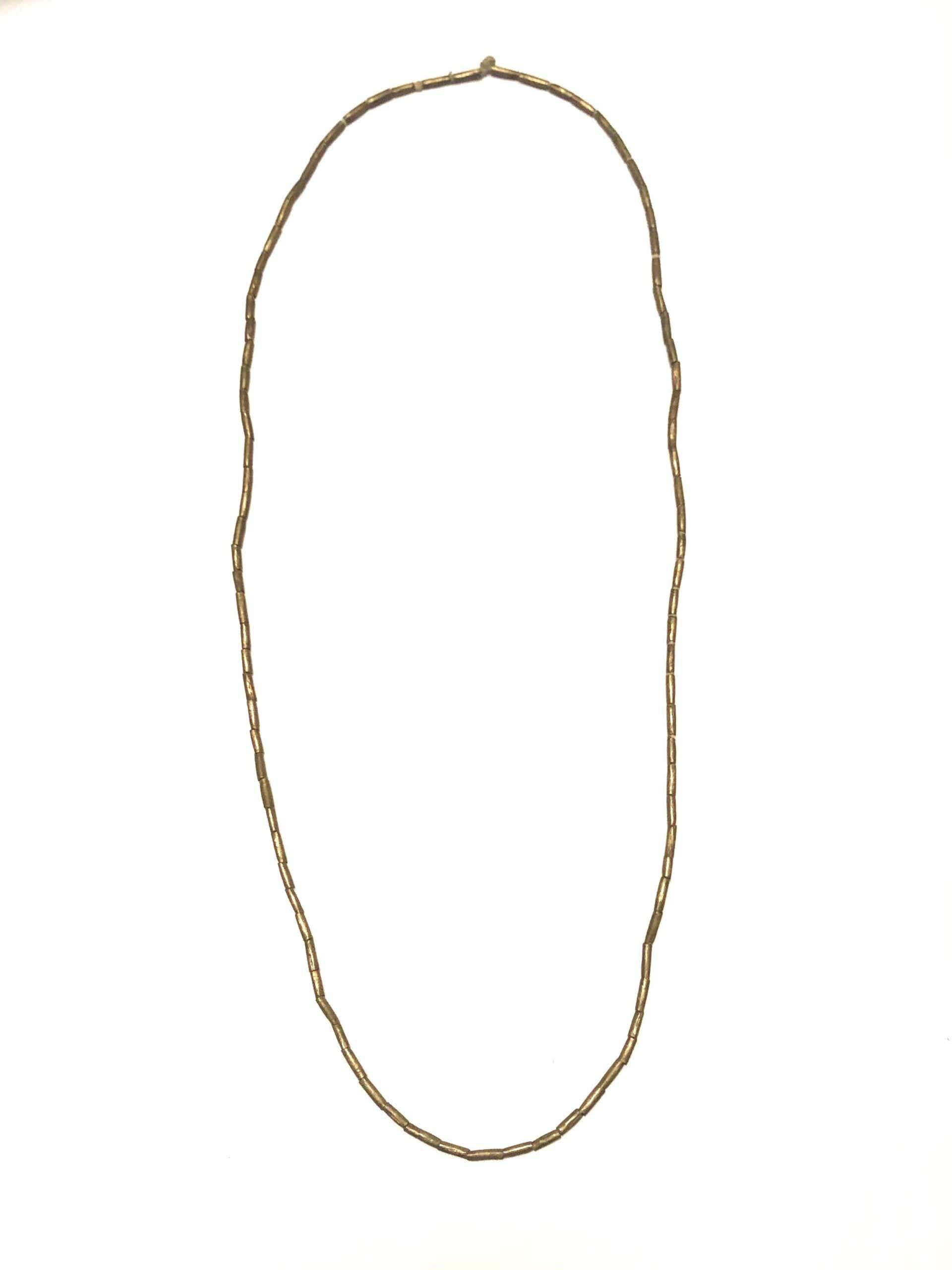 brass beaded necklace on white background