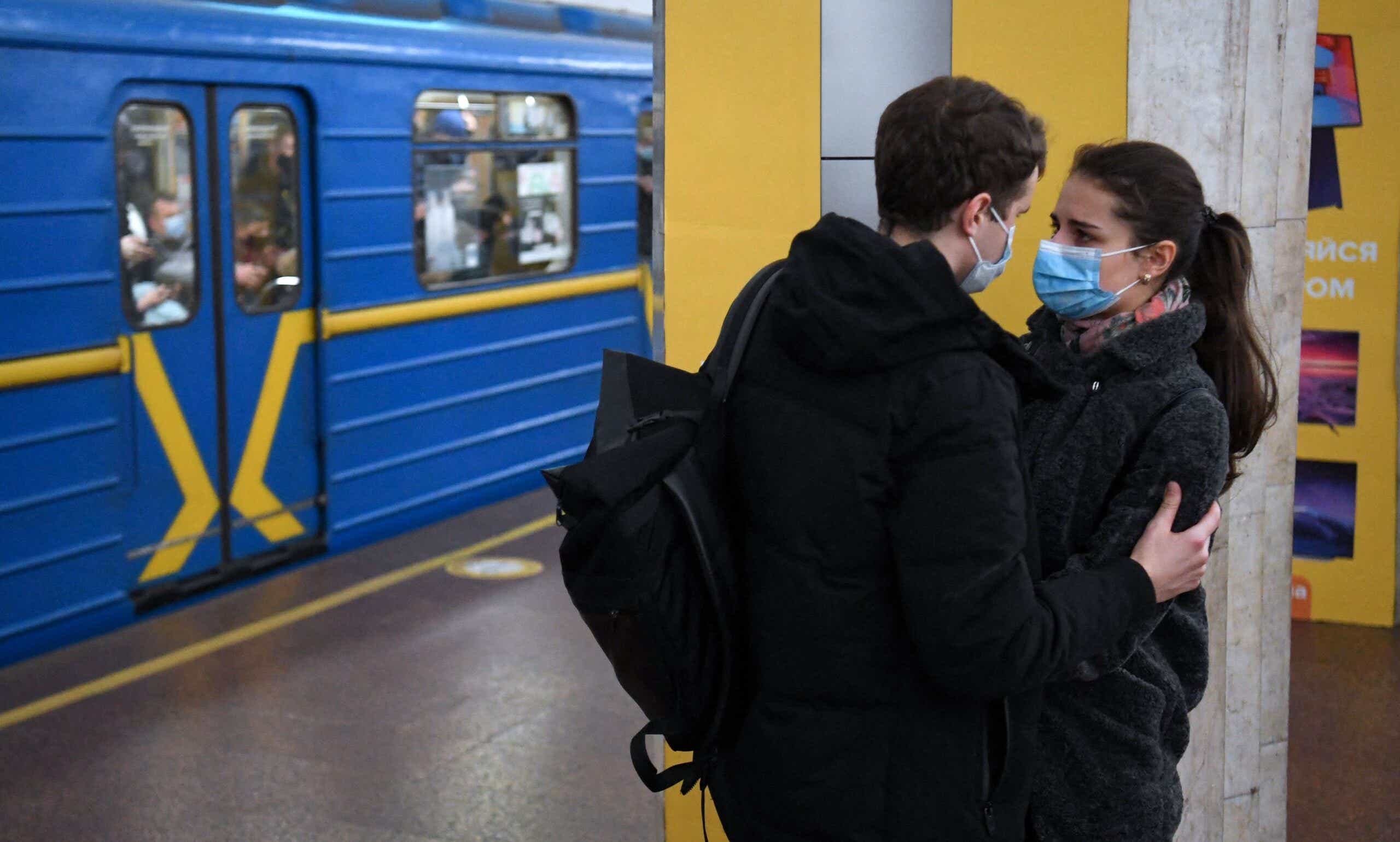 A scared-looking couple shared a moment this morning at a metro station in Ukraine's capital Kyiv