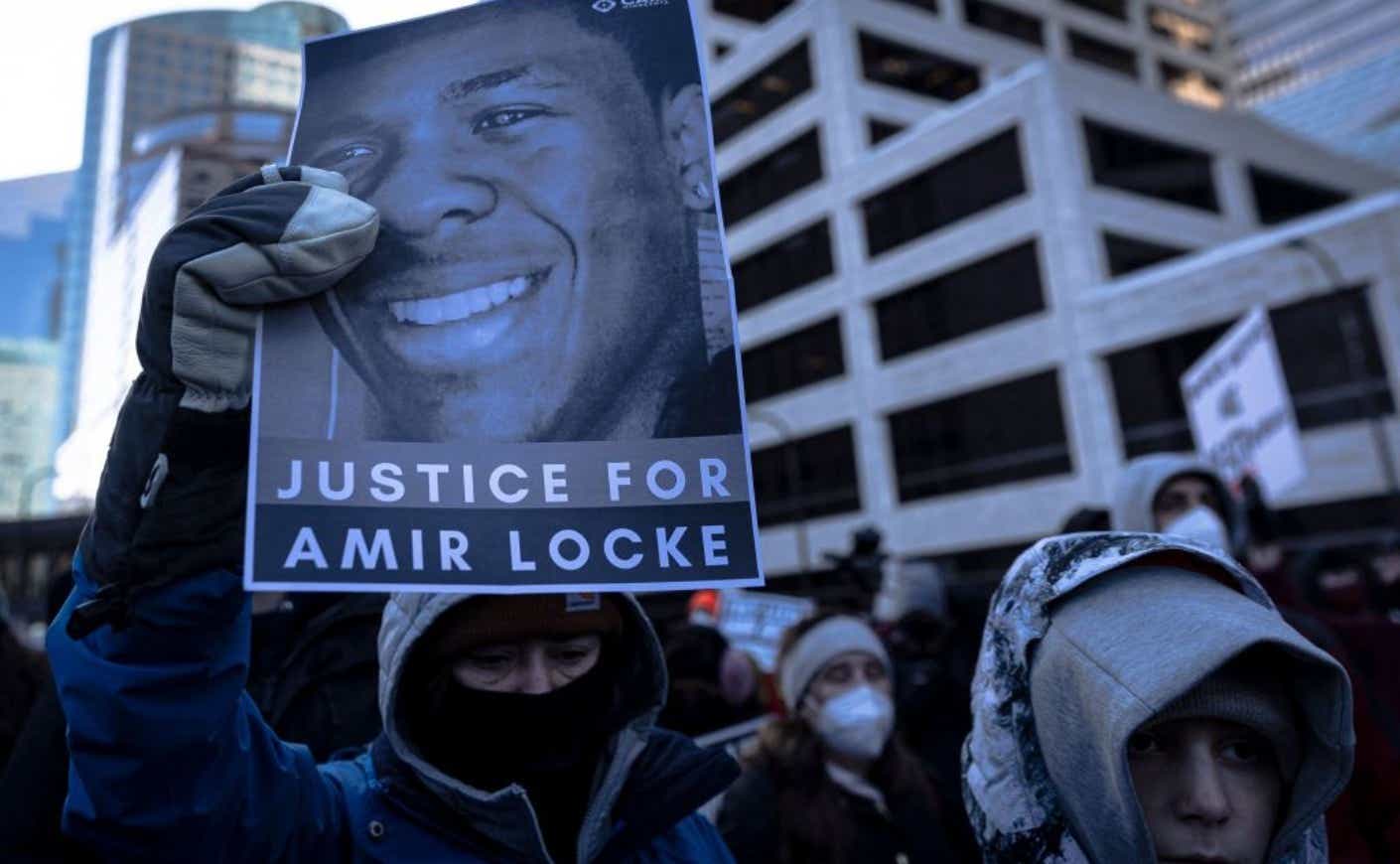 protestors holding up sign with Amir Locke's face