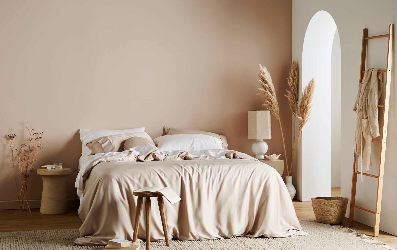 bed with beige sheets in beige room