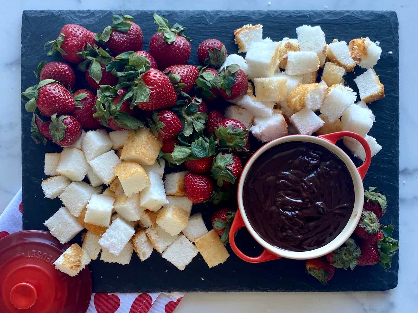 platter of chocolate fondue with cheese and fruit