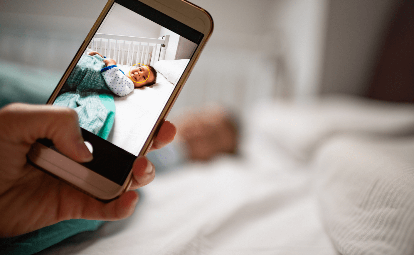 mother photographing baby with smart phone