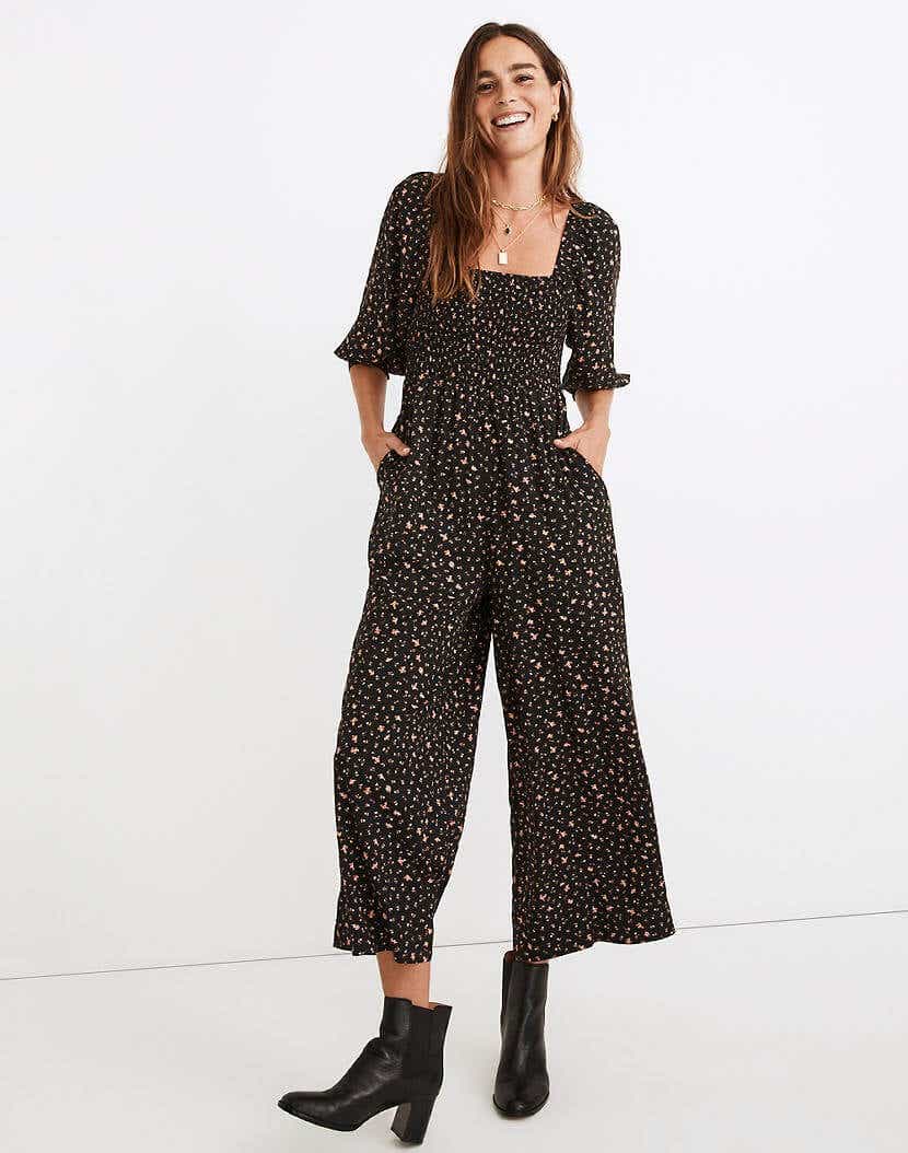 model wearing floral jumpsuit and boots