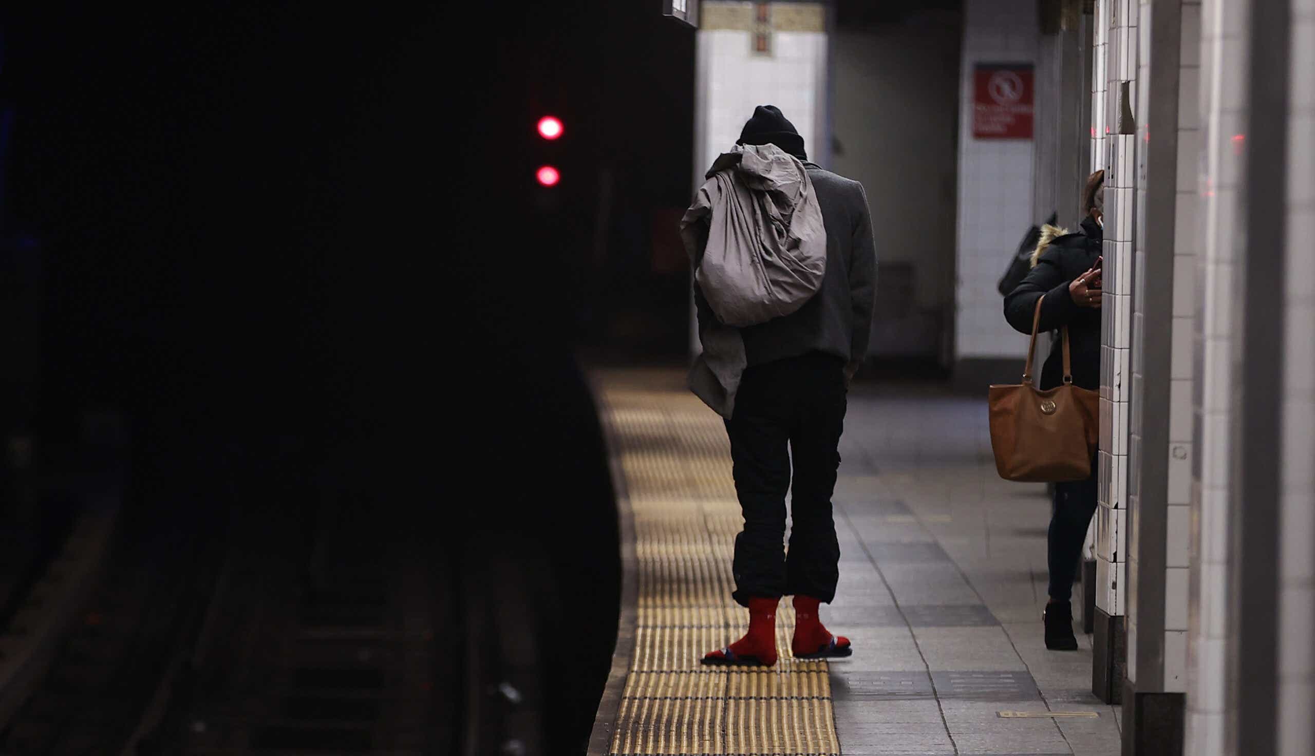 Homeless man on NYC subway platform