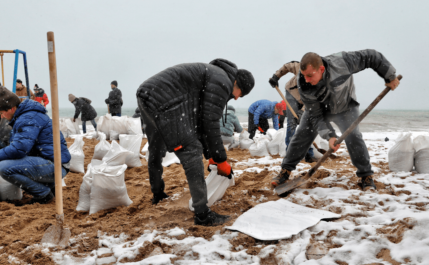 Men shovel sand into bags in Ukraine