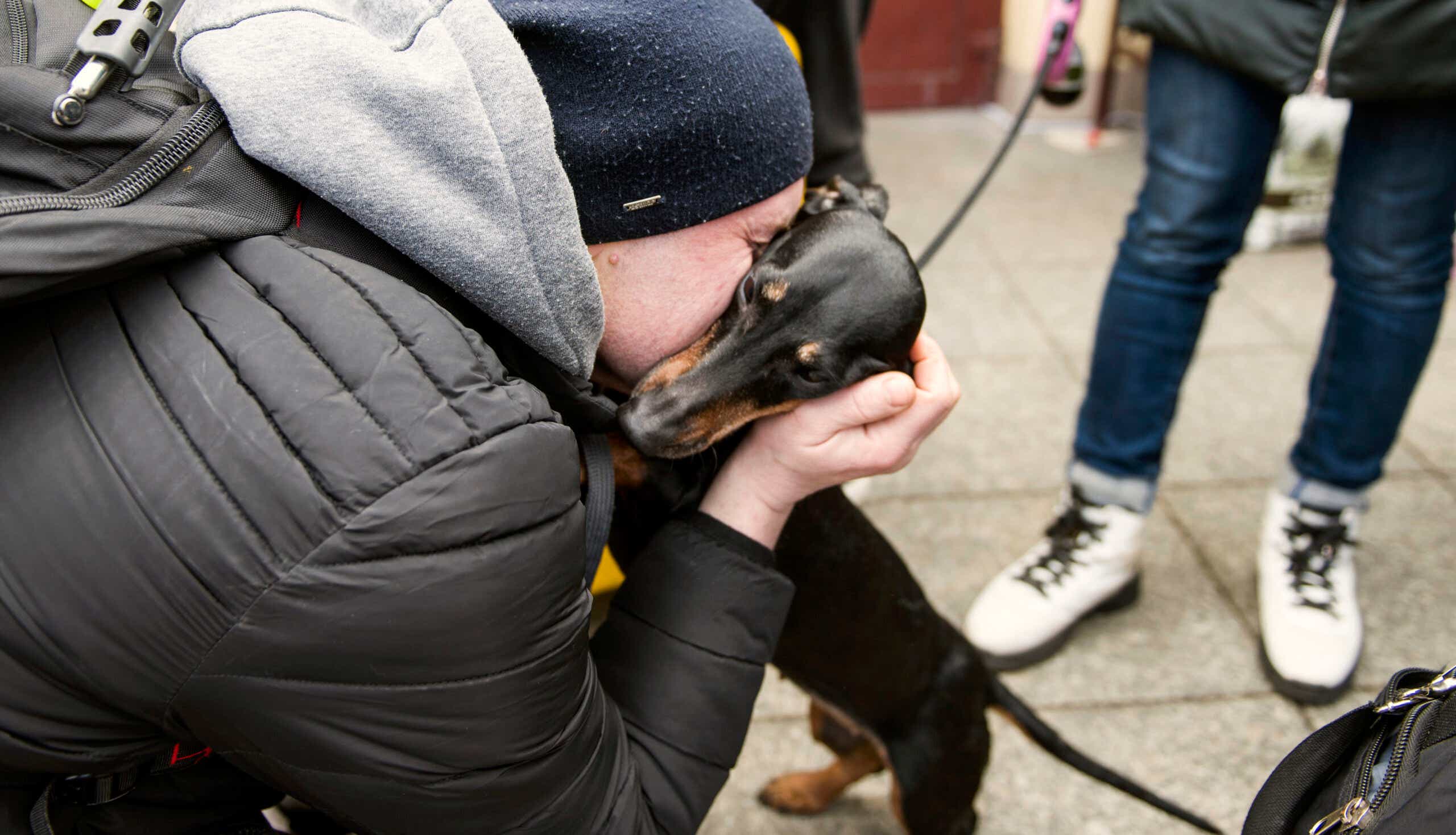 Ukrainian man kisses mini dachshund