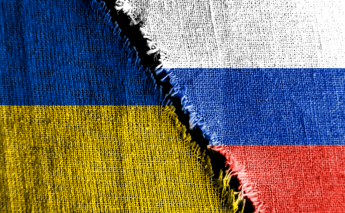 Russian and Ukraine flags torn in the middle