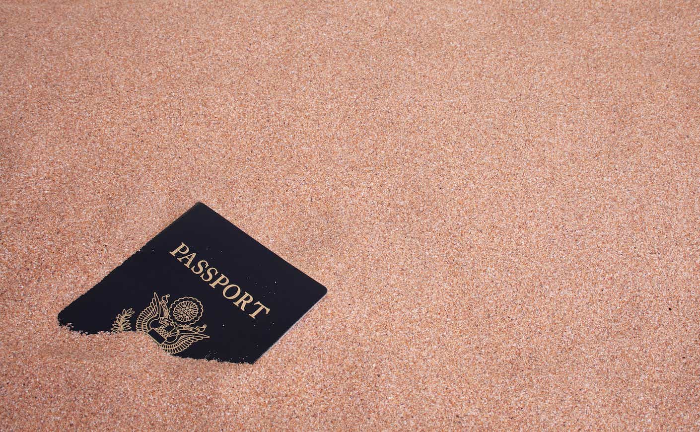 a U.S. passport buried in the sand