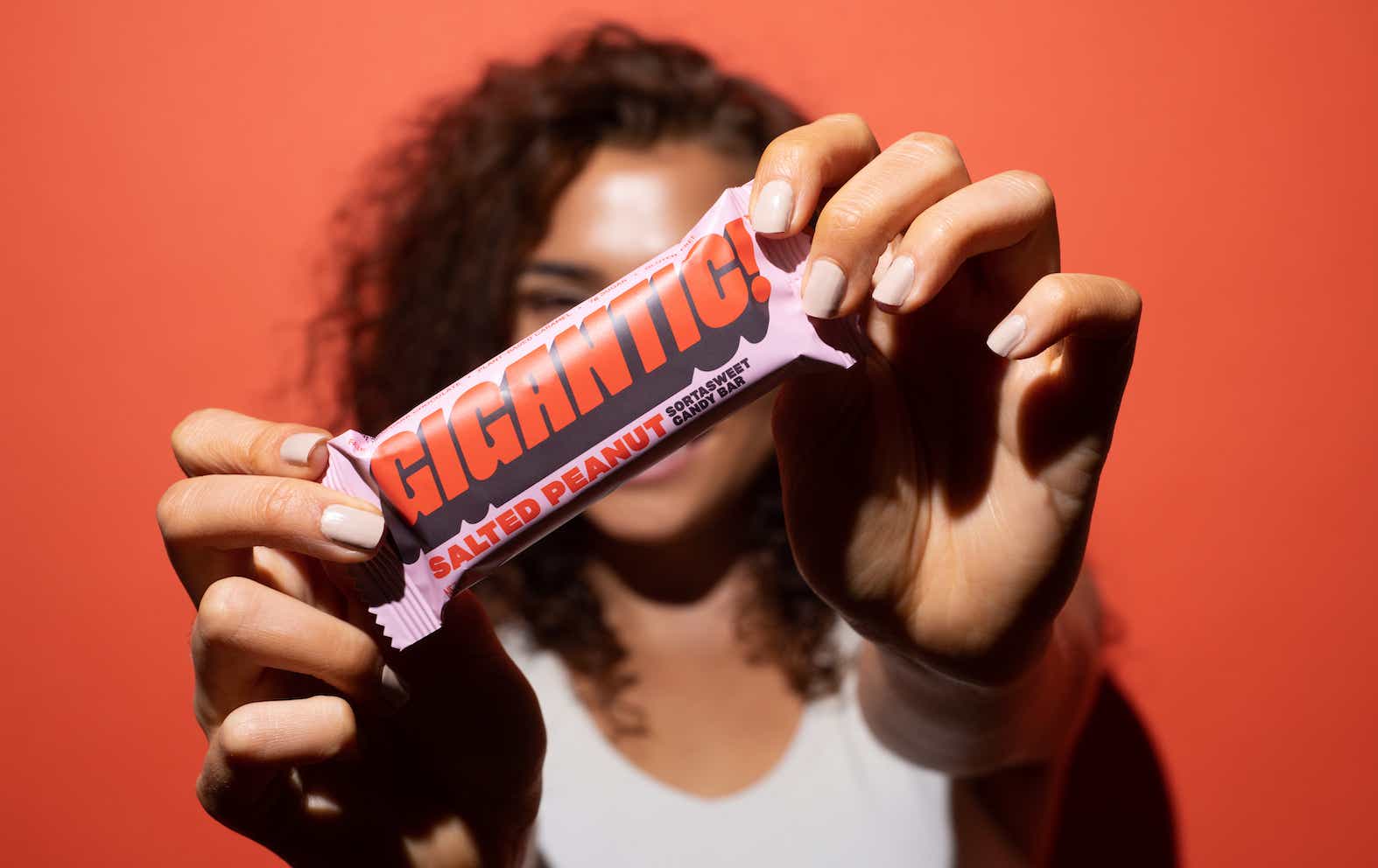 person holding up candy bar