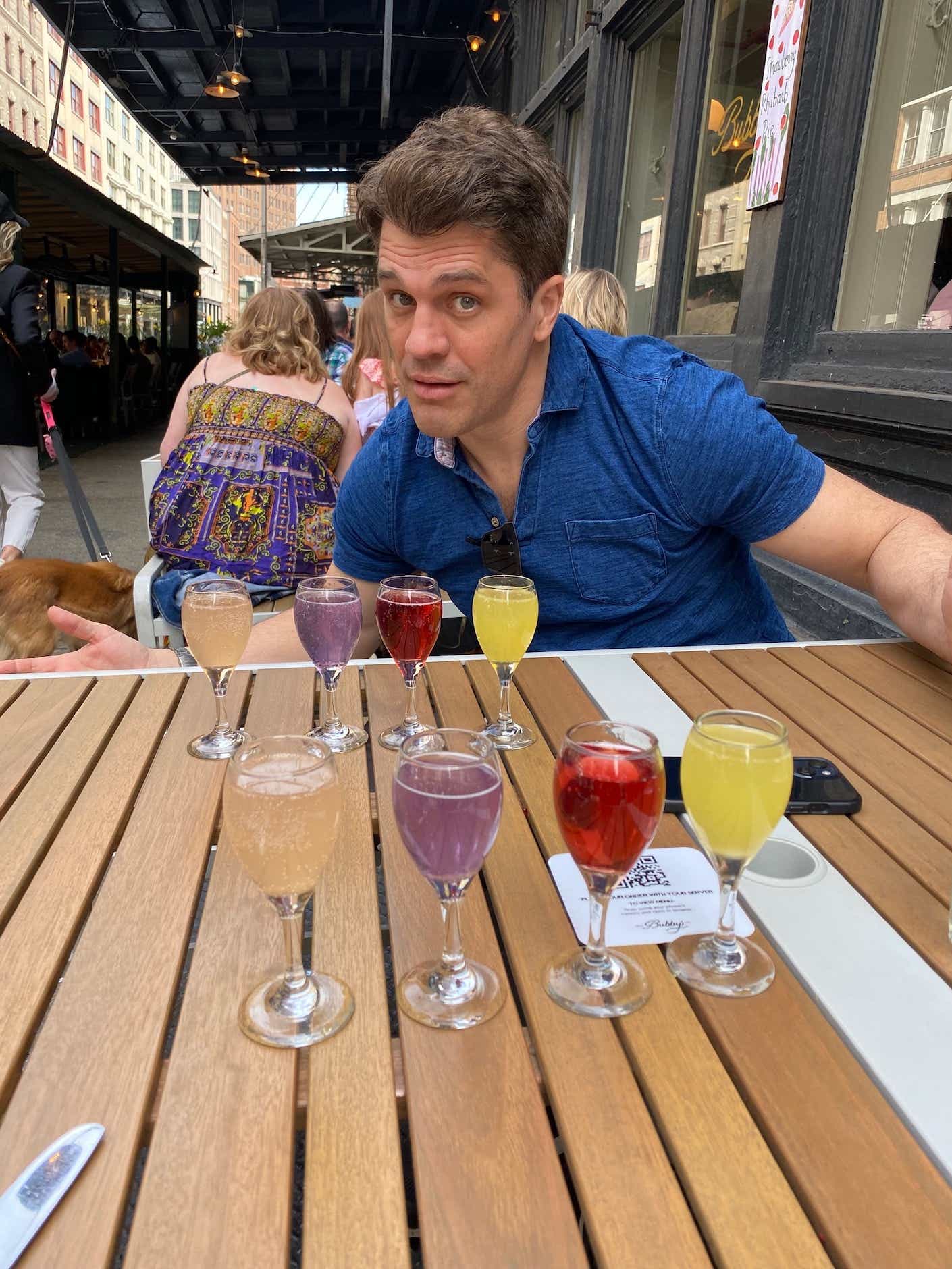 Katie Couric's nephew Jeff poses with a flight of mimosas