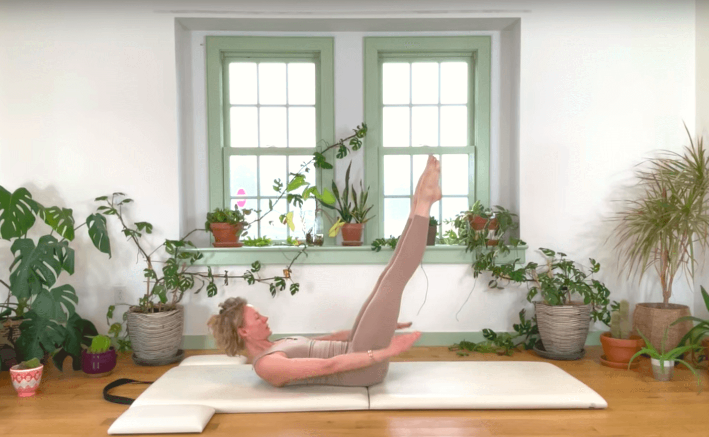 woman doing pilates moves on the floor