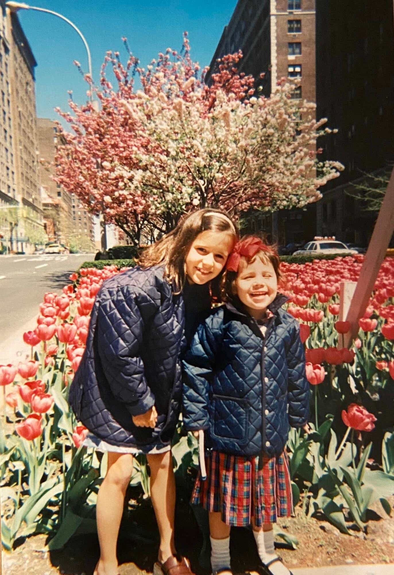 katie couric's daughters in front of a patch of tulips in nyc