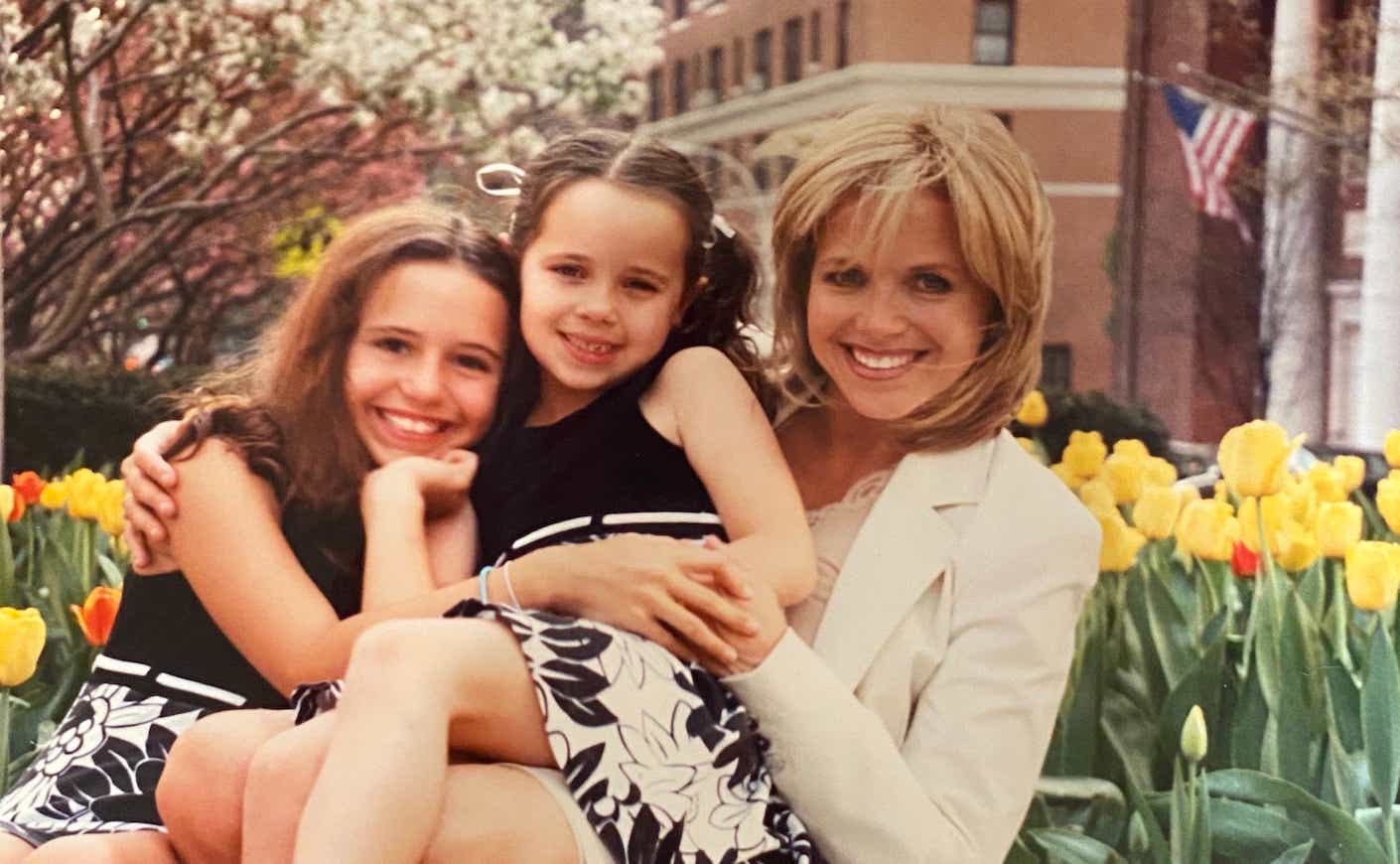 katie couric and her daughters in front of a patch of tulips