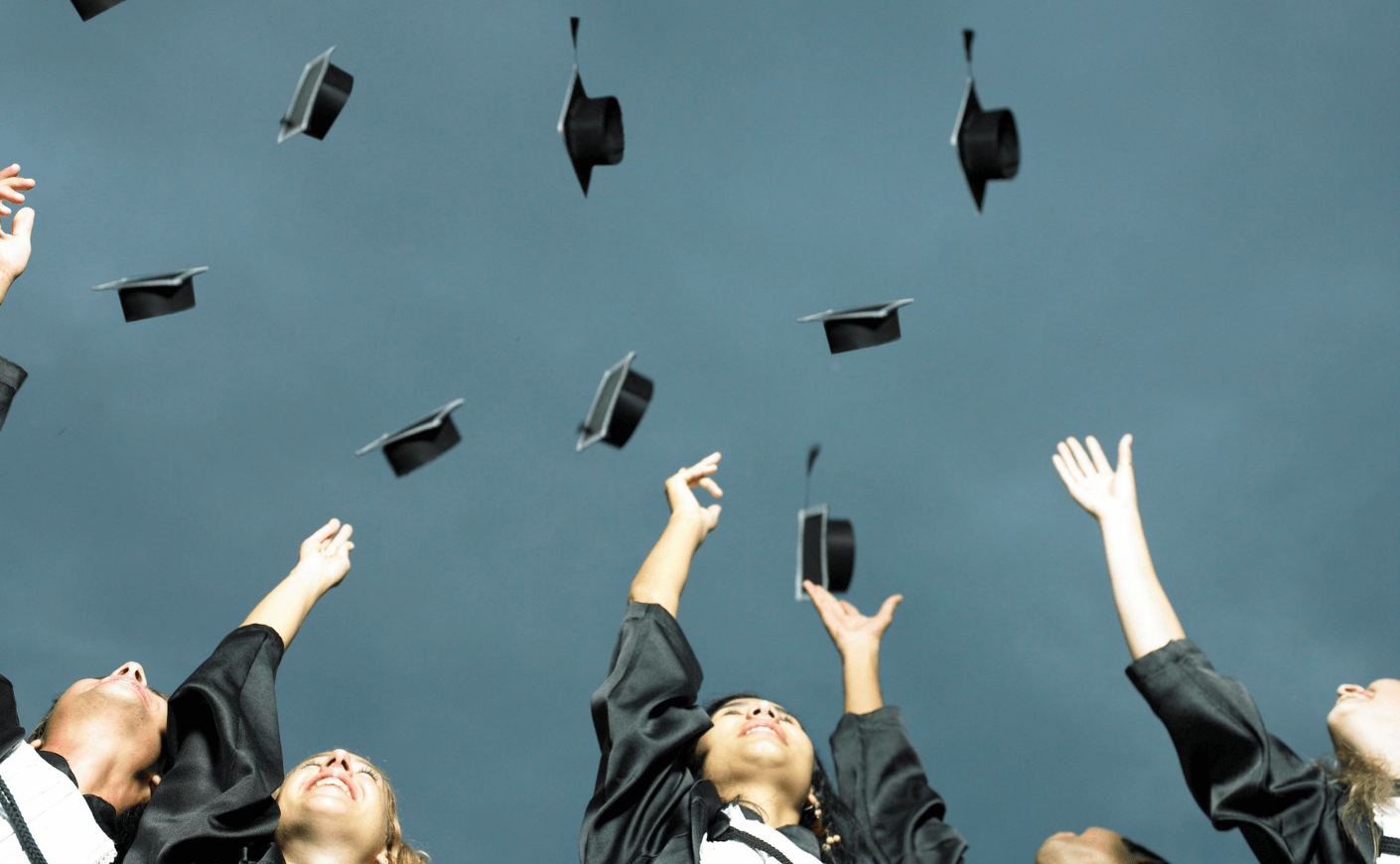 graduates tossing their caps in the air