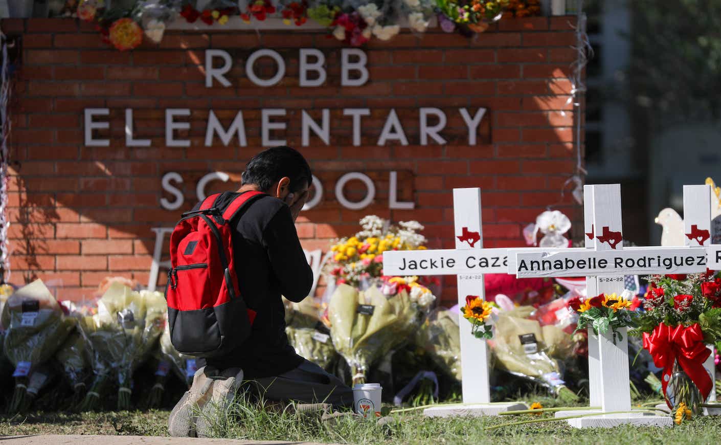 A man prays in front of a makeshift memorial outside Robb Elementary School in Uvalde, Texas