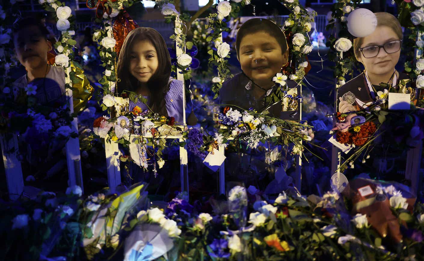 Flowers and photographs are seen at a memorial dedicated to the victims of the mass shooting at Robb Elementary School on June 2, 2022 in Uvalde, Texas.