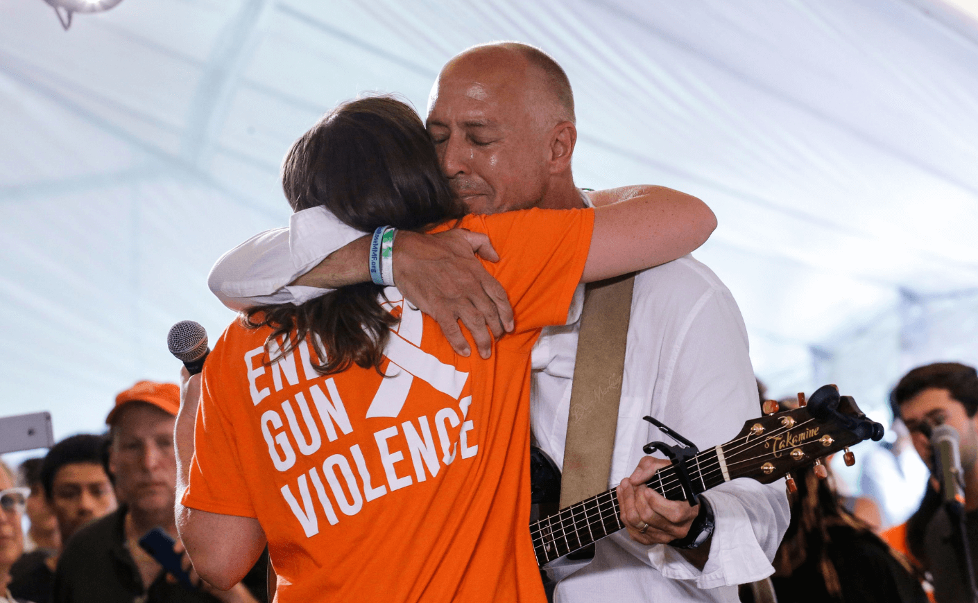 Mark Barden hugging a woman at a gun violence protest