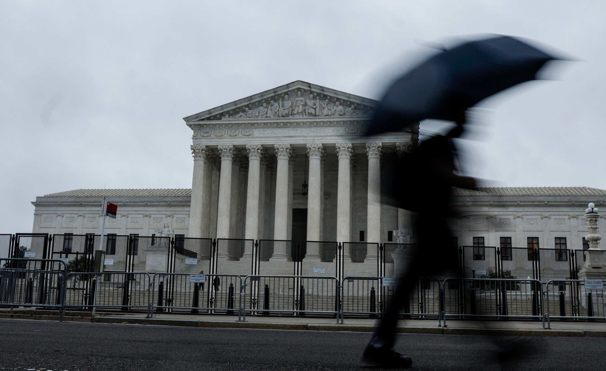 Man walking past the Supreme Court