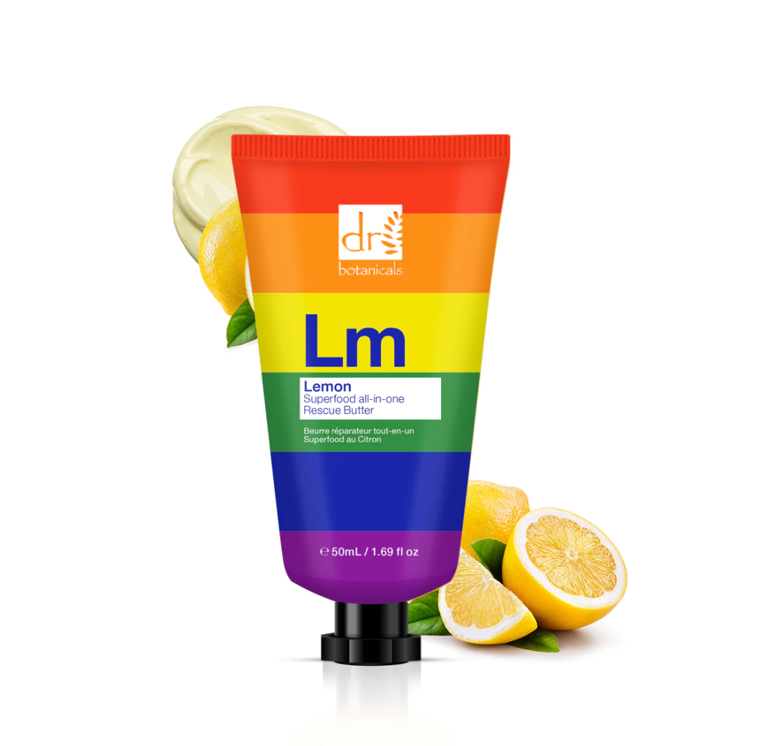 rainbow striped tube of body butter with lemons behind it