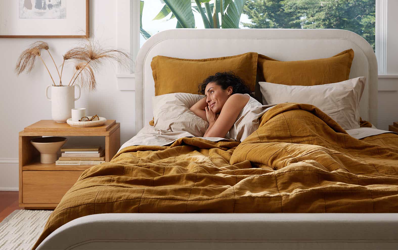 Woman sleeping in a bed with Parachute linens