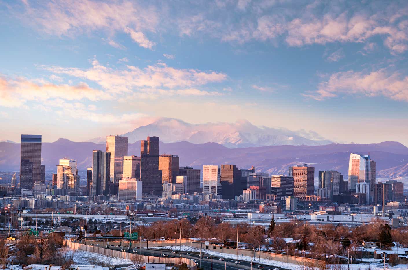 Downtown Denver, Colorado set against the backdrop of mountains.