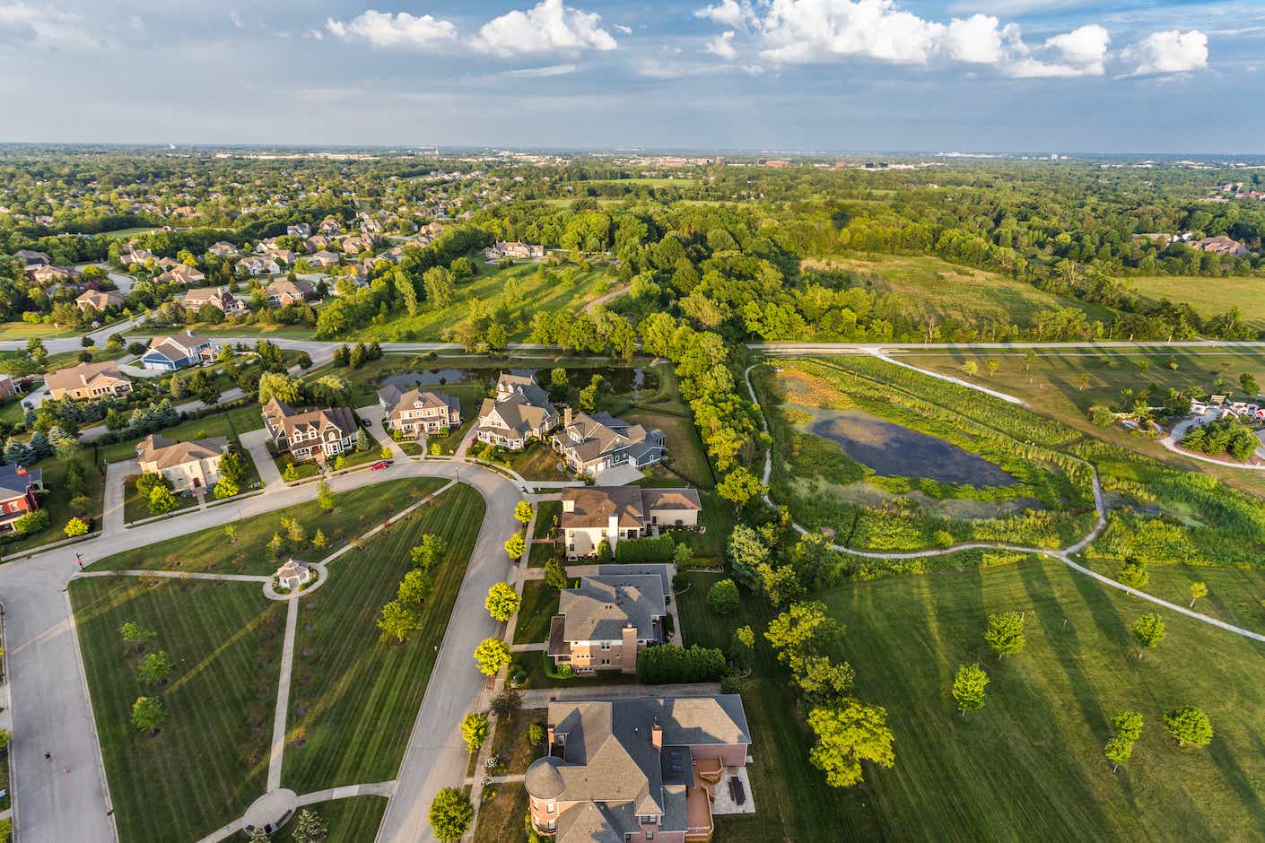 An aerial shot of a leafy, green suburban neighborhood in Carmel, Indiana.
