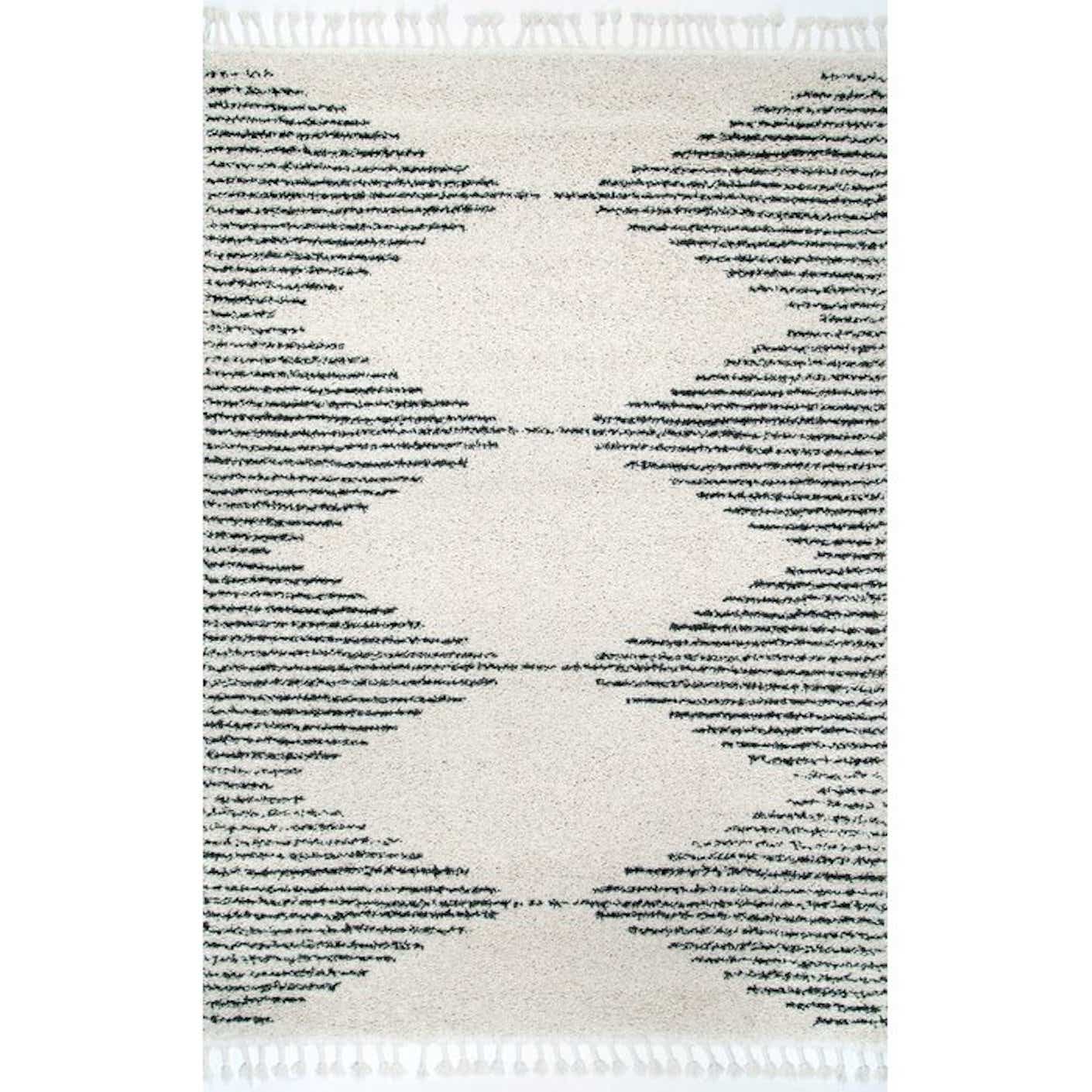 A black and white, geometric-patterned rug pictured in front a plain white background.
