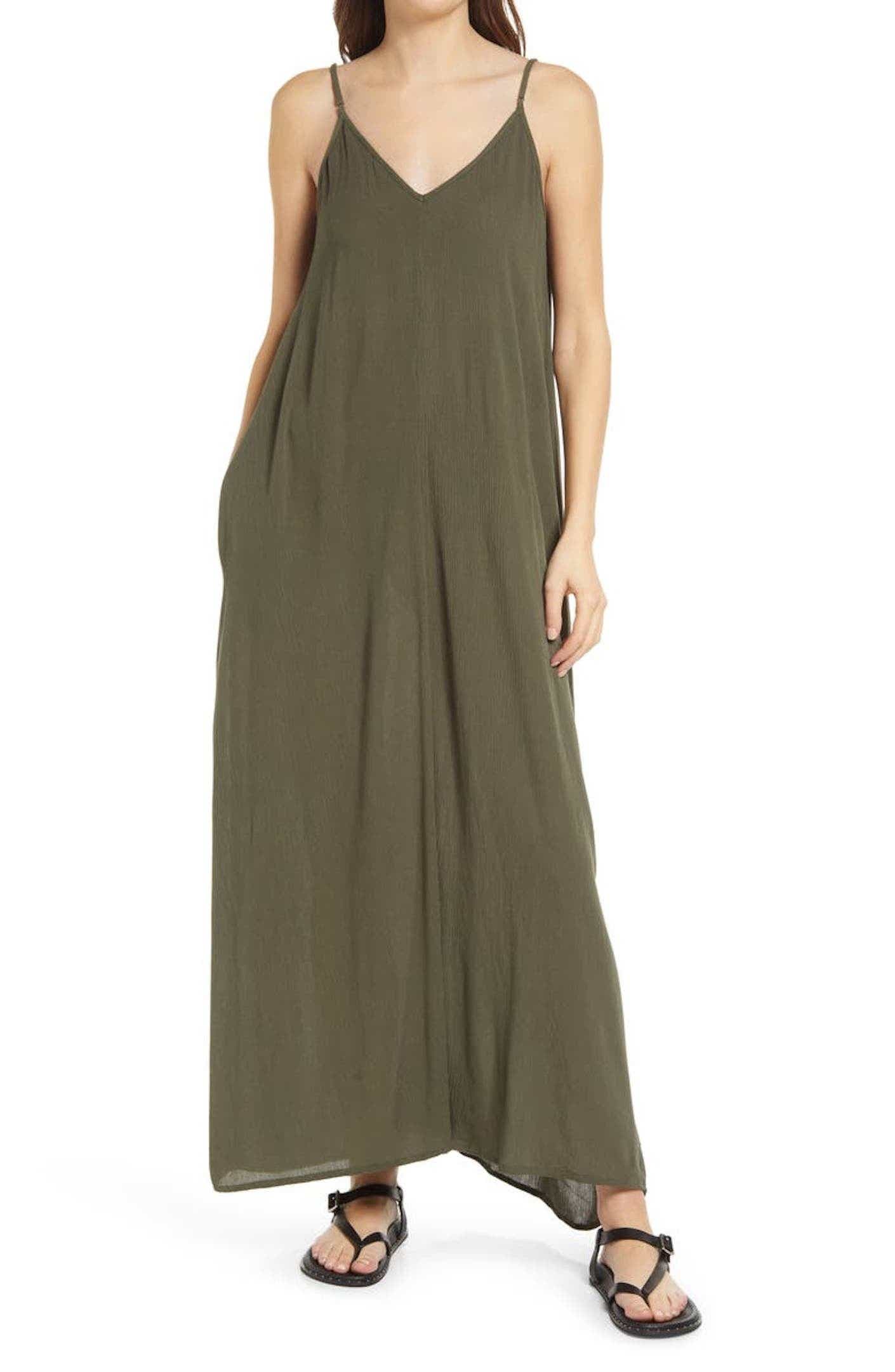 A person wearing a flowy, olive green maxi dress.