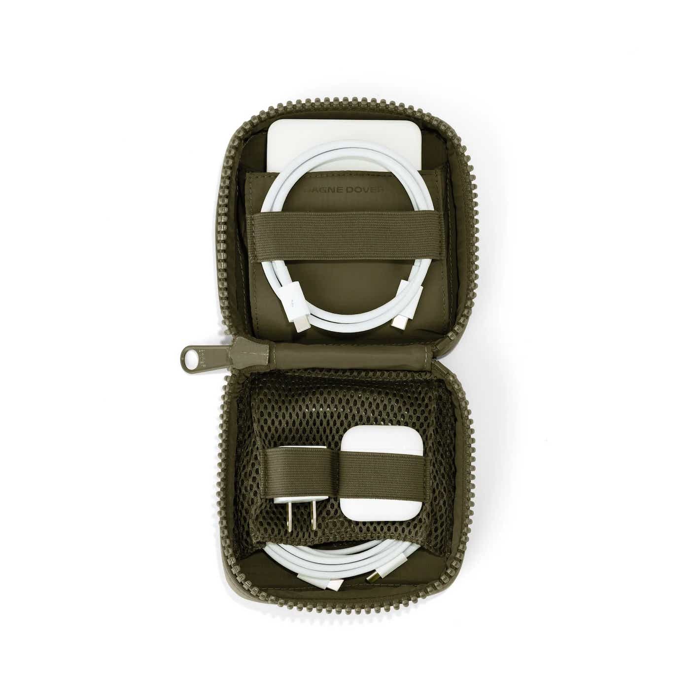 A moss green, square tech organizer is zipped open, showing its contents (organized chargers and cords).