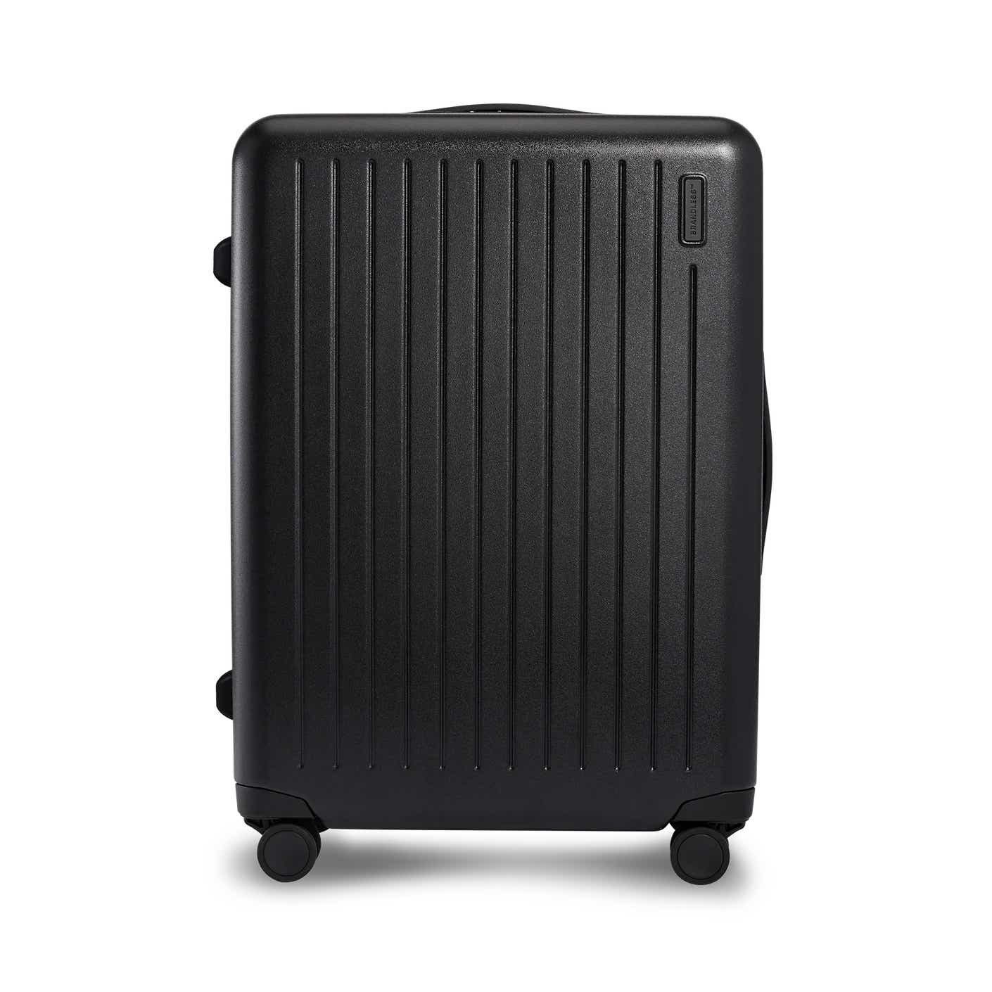 A hardsided black suitcase pictured in front of a white background.